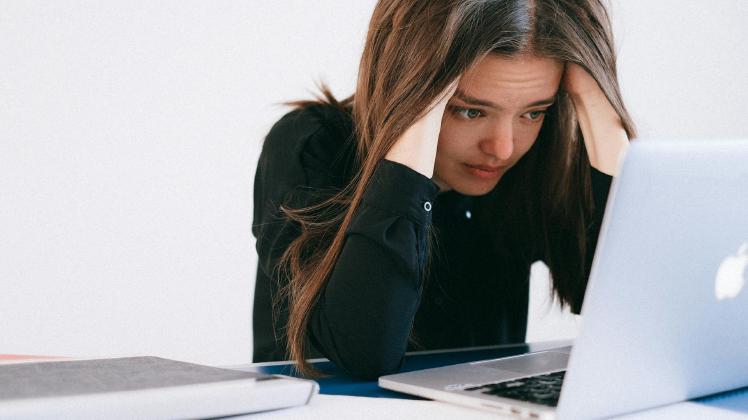 Mulher estressada olhando para um laptop — foto por Anna Shvets no Pexels